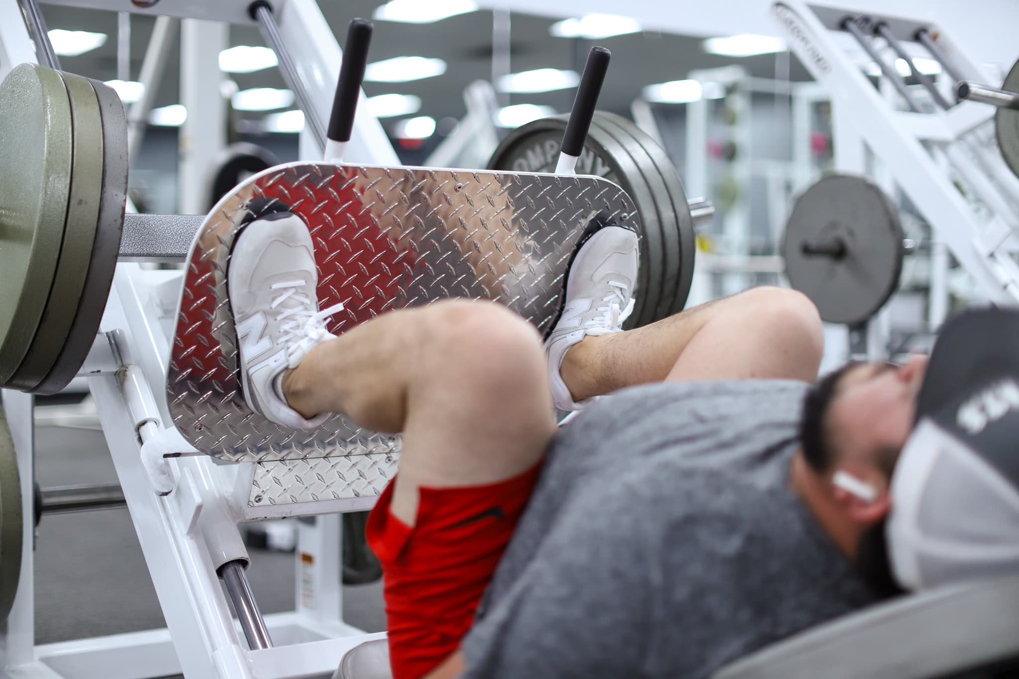 Member training on a plate-loaded machine at Legends Gym