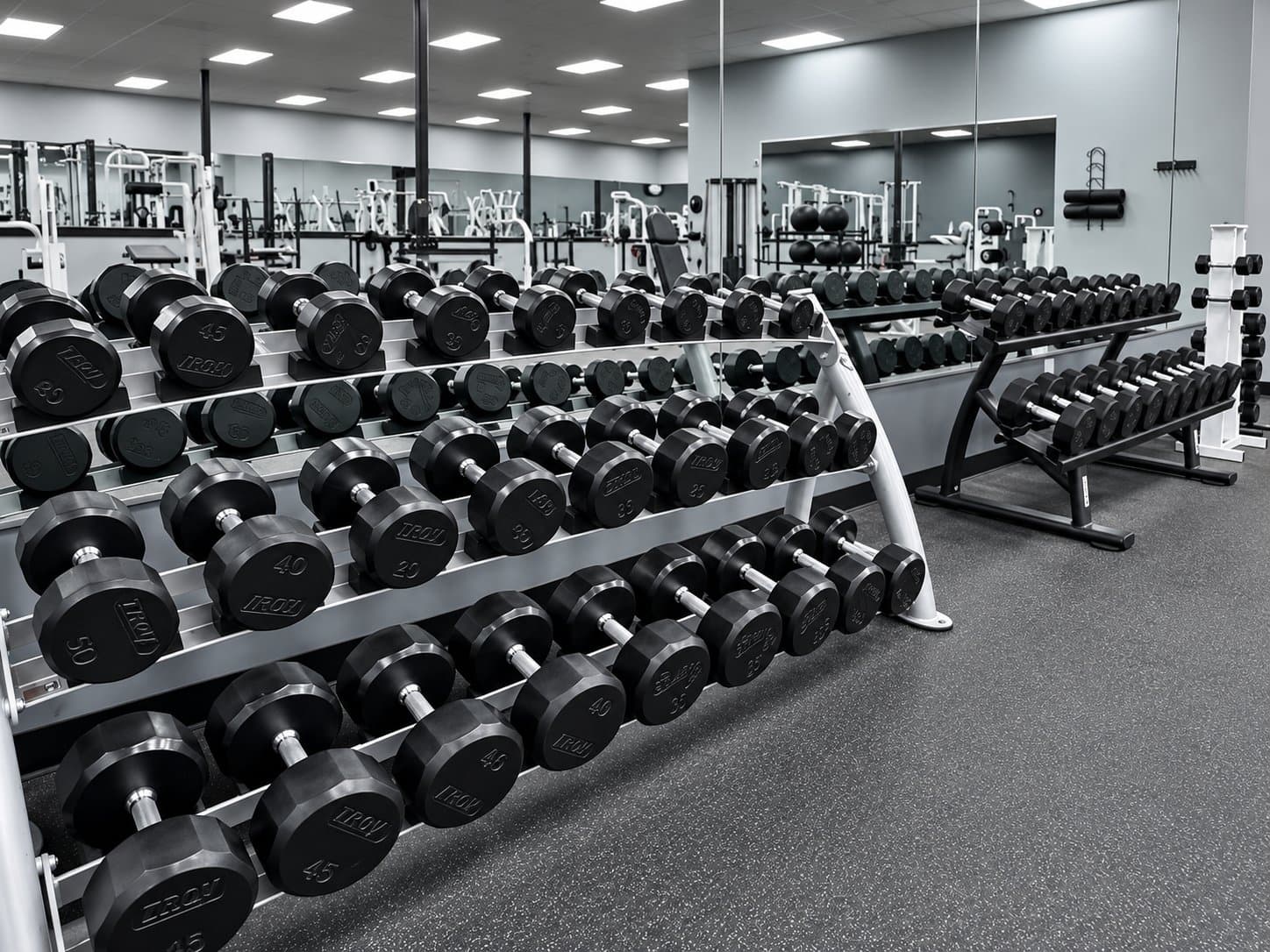 Dumbbell racks and strength equipment inside Legends Gym